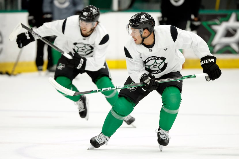 Dallas Stars centers Logan Stankoven (11, right) and Mavrik Bourque (22) race down ice for...