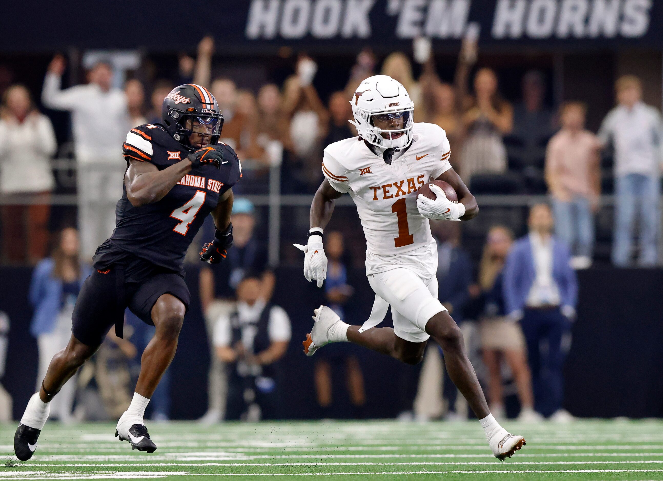 Texas Longhorns wide receiver Xavier Worthy (1) breaks away from Oklahoma State Cowboys...