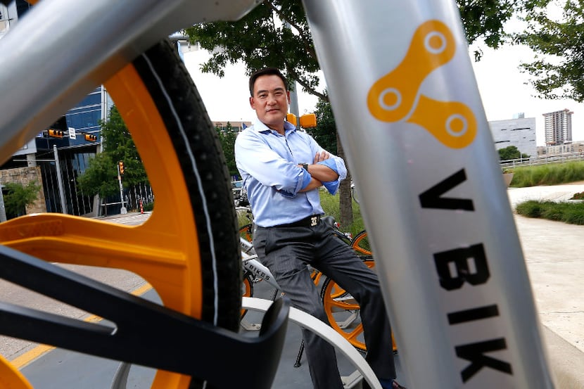David Shan, president of VBikes, poses for a photograph with the units parked at Klyde...