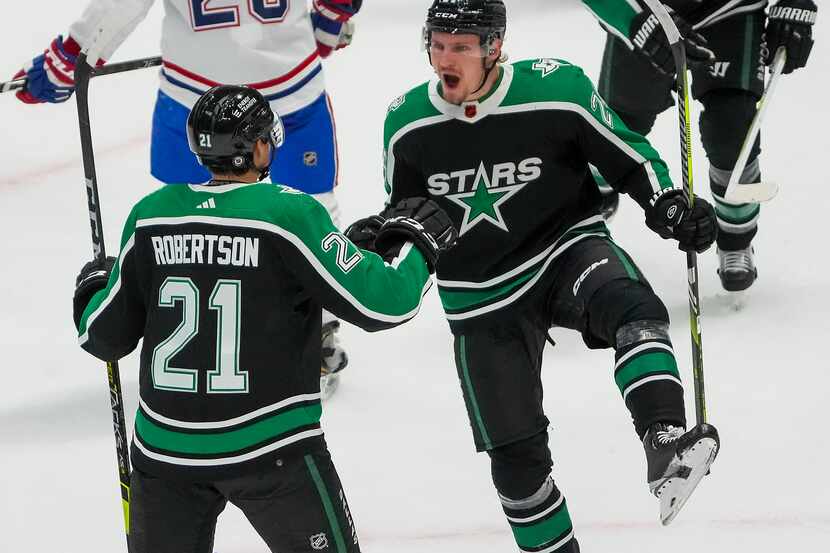 Dallas Stars center Roope Hintz (24) celebrates with left wing Jason Robertson (21) and...