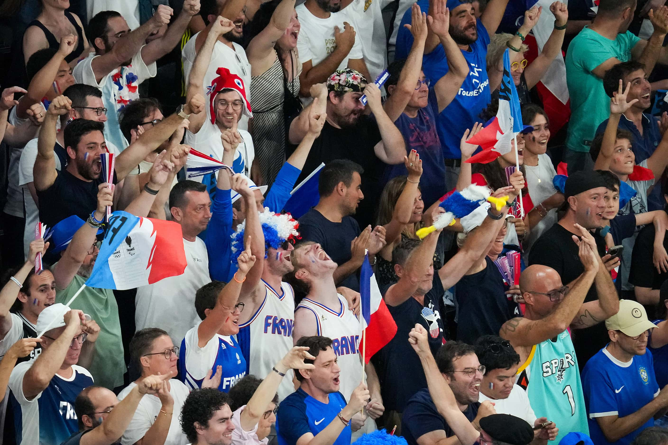 French fans cheer their team during a victory over Canada in a men’s basketball quarterfinal...