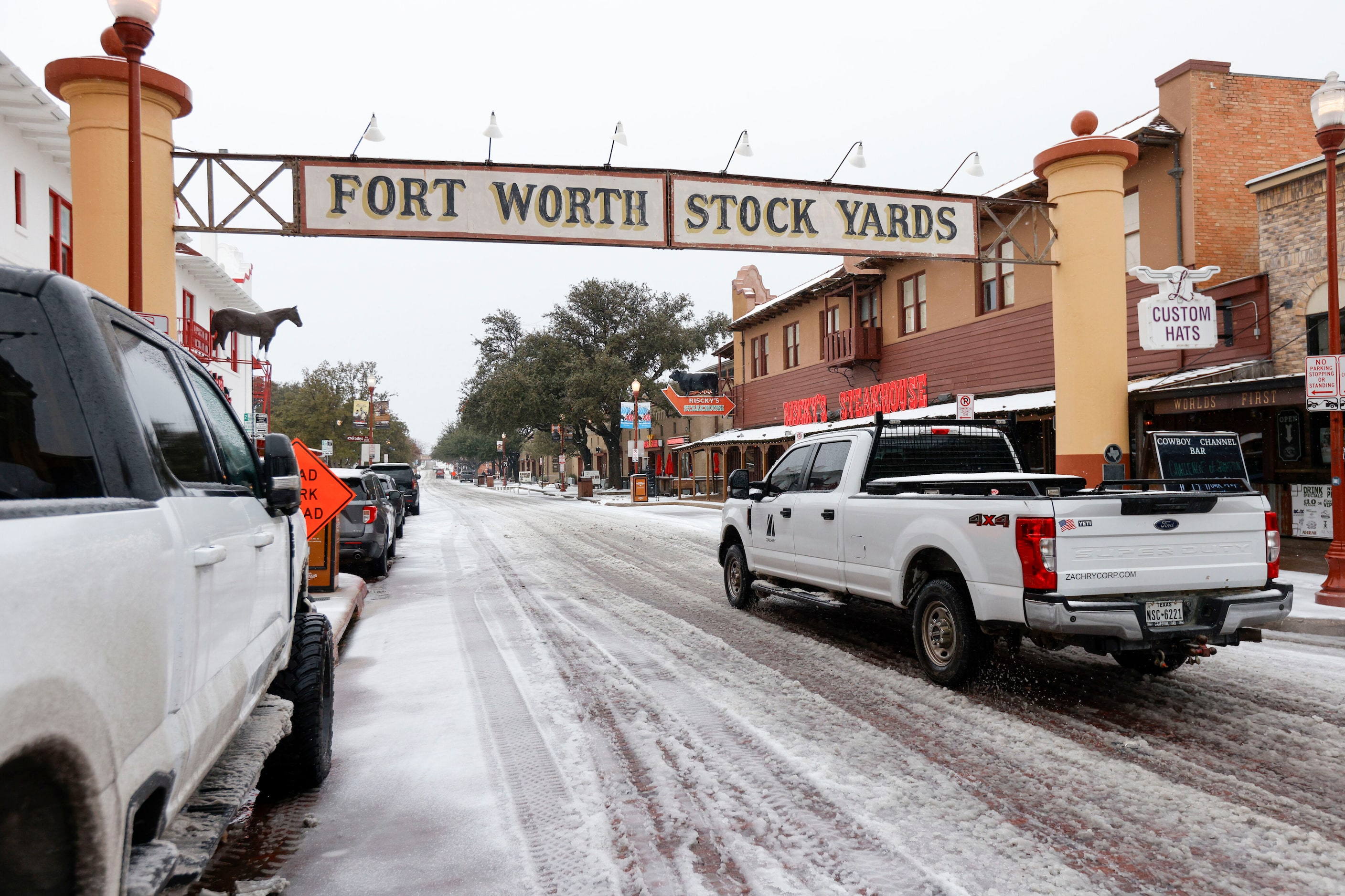 A truck drives an ice covered East Exchange Avenue in the Fort Worth Stockyards, Thursday,...