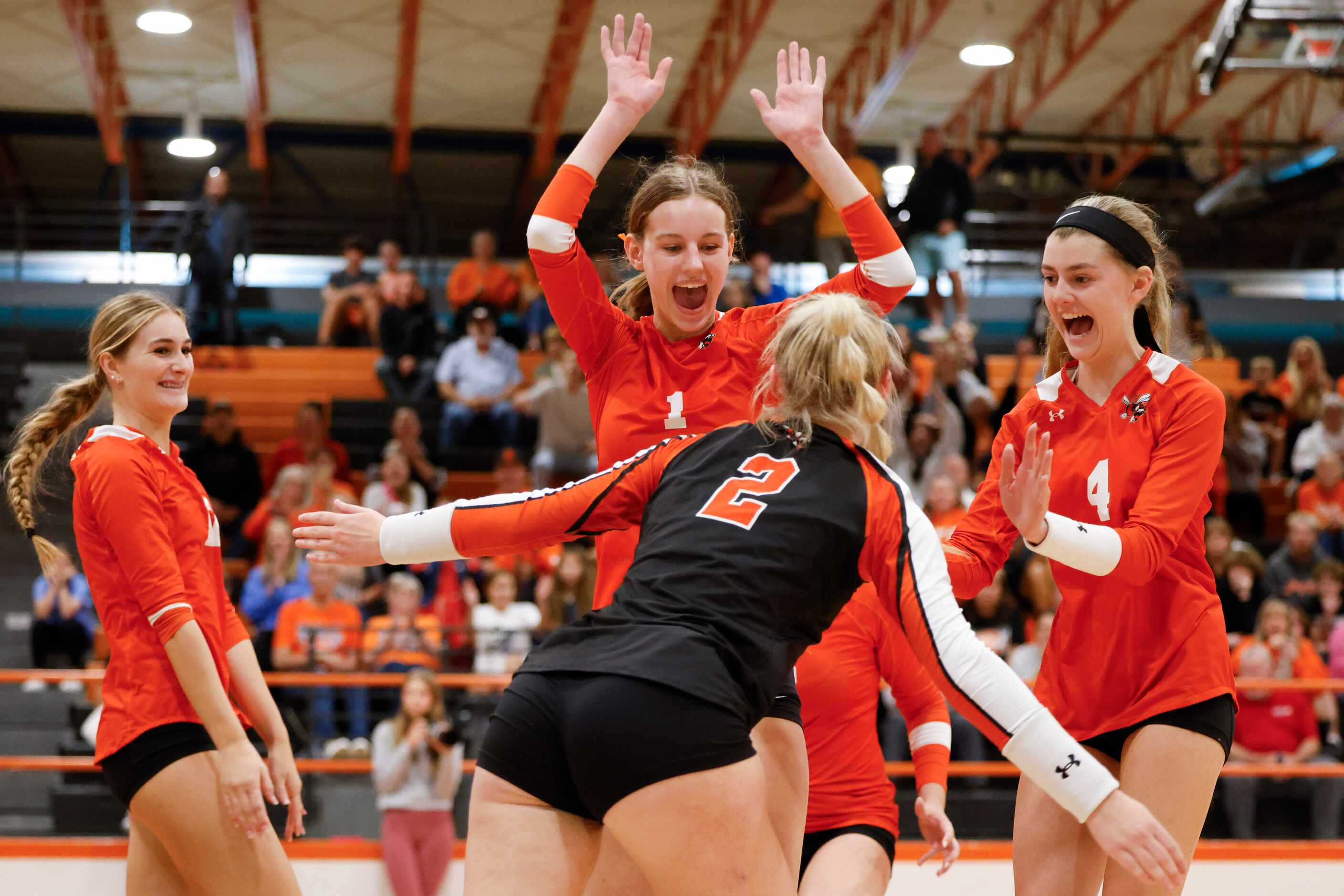 Rockwall high’s Halle Jameson (1) and Alyson Wurster (4) cheers towards Sophia Armstrong (2)...