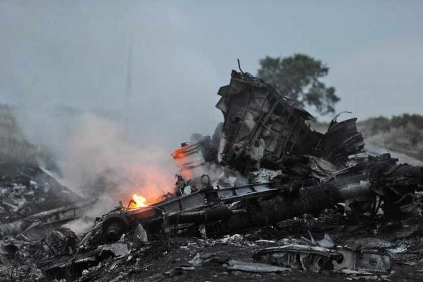 
Flames leap from the wreckage of the Malaysian Airlines passenger jet carrying 295 people...