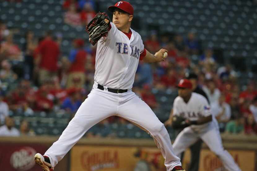 Texas Rangers starting pitcher Derek Holland (45) throws a pitch during the Los Angeles...