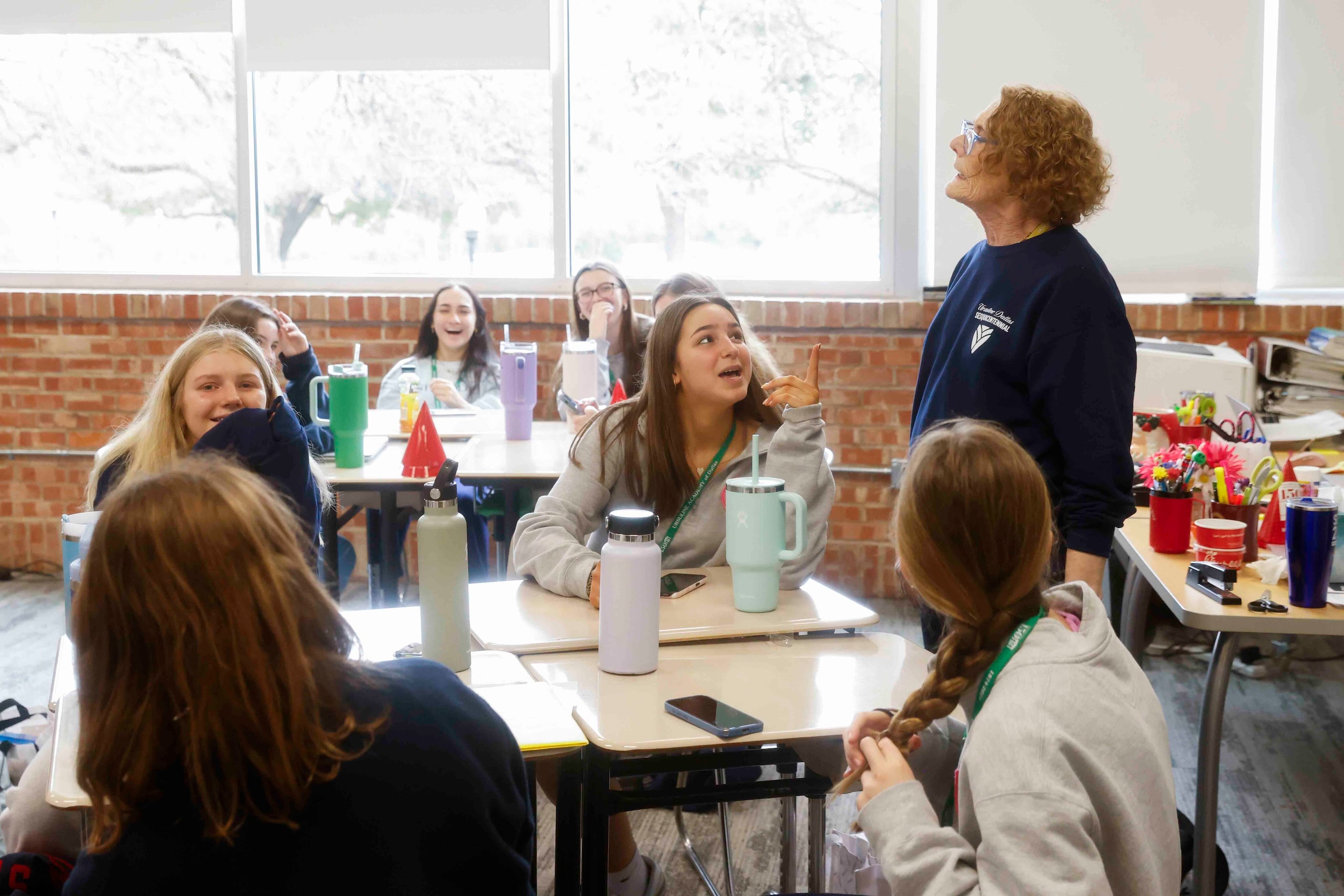 Students react towards theology teacher Suzy Frasco while in class during the 150th...