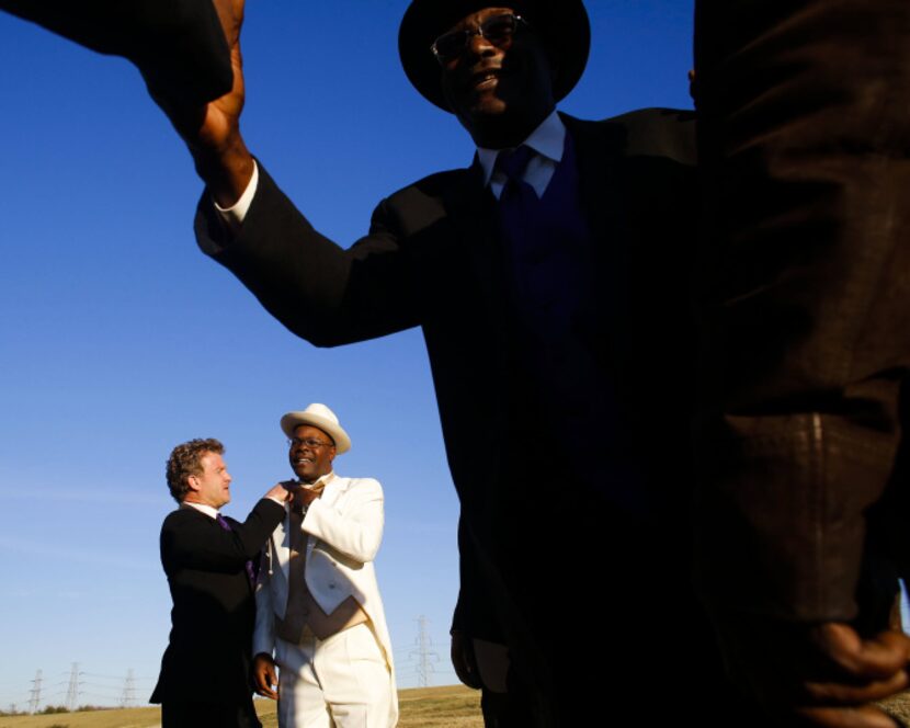 Milton Baker is prepared by his groomsmen before his wedding at the community day I Love...