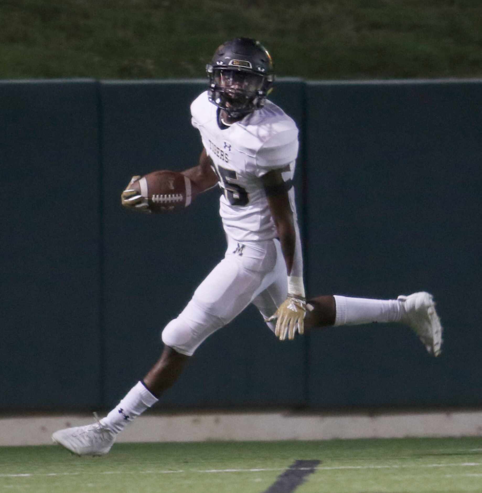 Mansfield running back Nicholas Lloyd (25) races out of the end zone following his first...