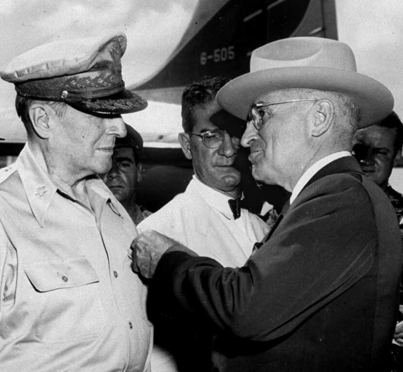 President Truman pins the Distinguished Service Medal on the shirt of Gen. Douglas MacArthur...