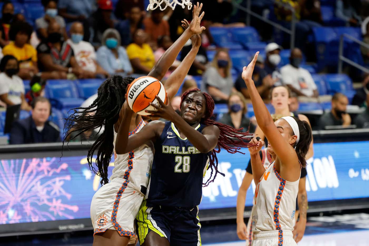 Dallas Wings center Awak Kuier (28) is fouled by Connecticut Sun forward Beatrice...