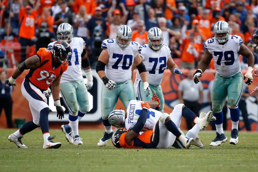 Dallas Cowboys quarterback Dak Prescott (4) is sacked by Denver Broncos outside linebacker...