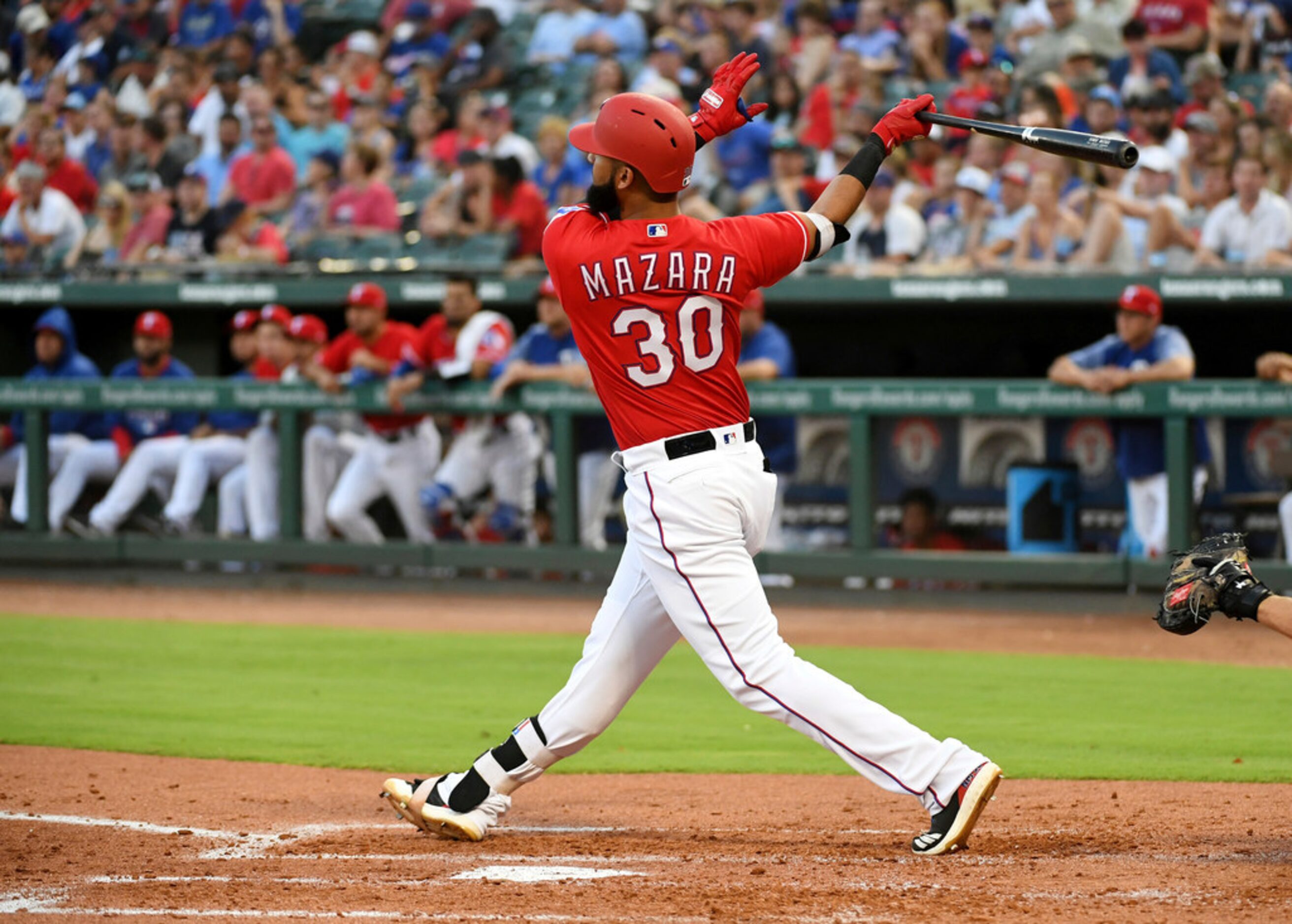 Texas Rangers' Nomar Mazara follows through on a three-run home run off Chicago White Sox...