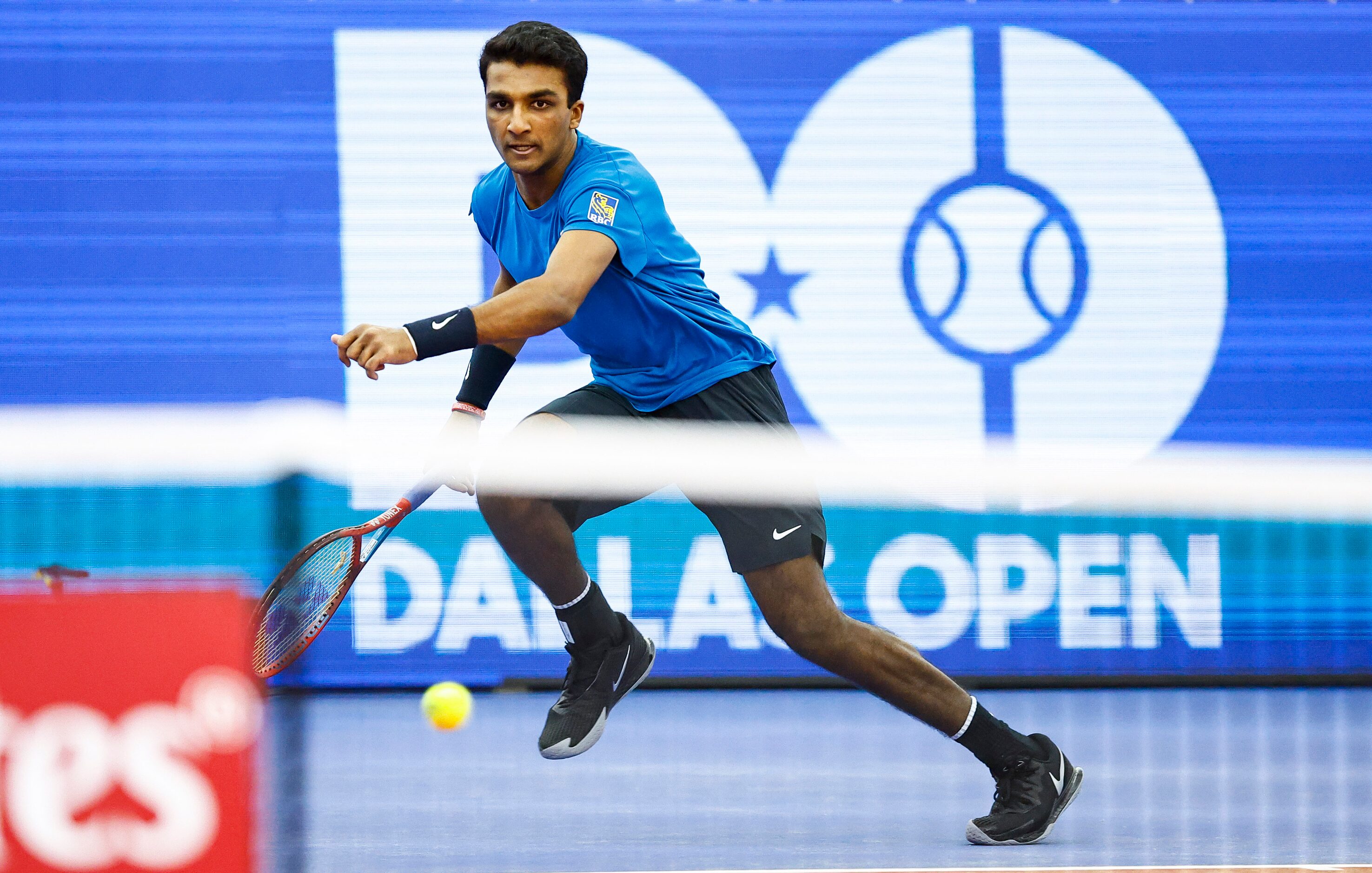 SMU senior Caleb Chakravarthi returns the ball in a match against Vasek Pospisil during the...