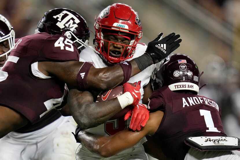 New Mexico running back Jacory Croskey-Merritt (5) is tackled by Texas A&M linebacker...