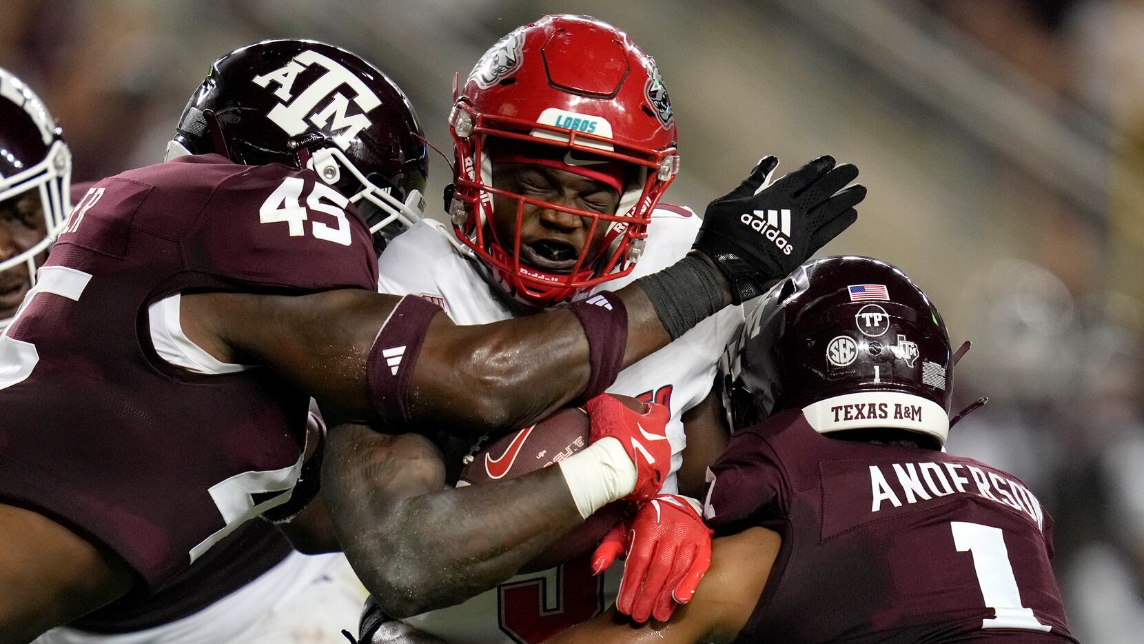 New Mexico running back Jacory Croskey-Merritt (5) is tackled by Texas A&M linebacker...