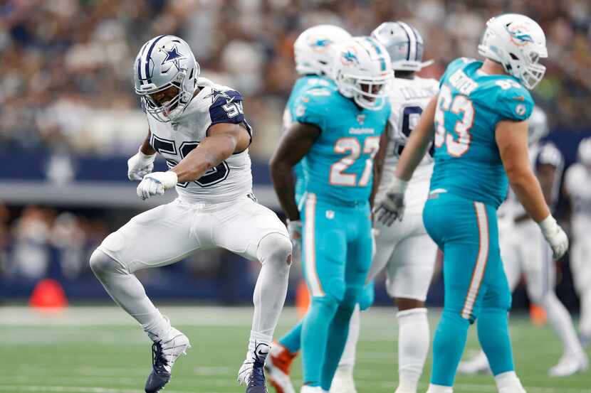 Dallas Cowboys defensive end Robert Quinn (58) celebrates after sacking Miami Dolphins...