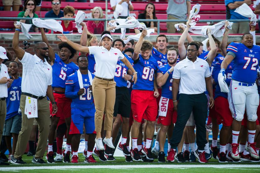 Southern Methodist Mustangs cheer on their team from the sideline before kick-off of a...