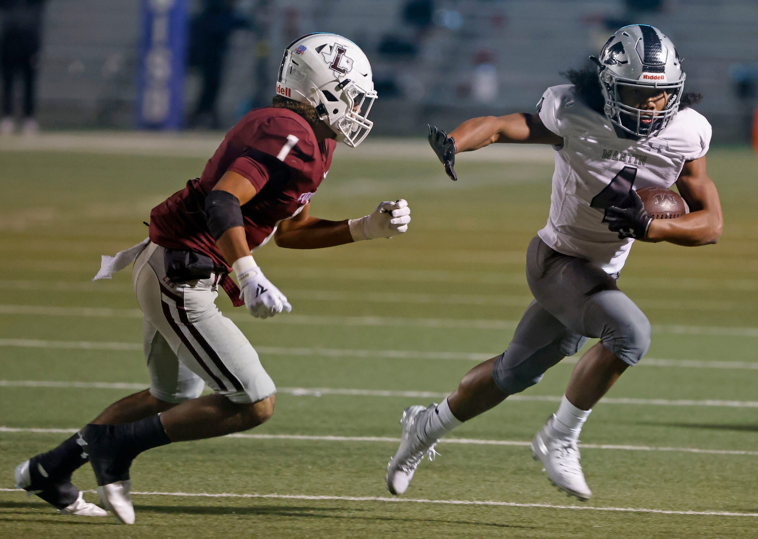 Arlington Martin running back Zaire Barrow (4) runs past Lewisville defender Jaydan Hardy...