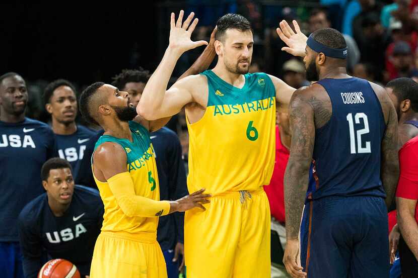 Andrew Bogut (6) of Australia holds up his hands as he is approached by Demarcus Cousins...