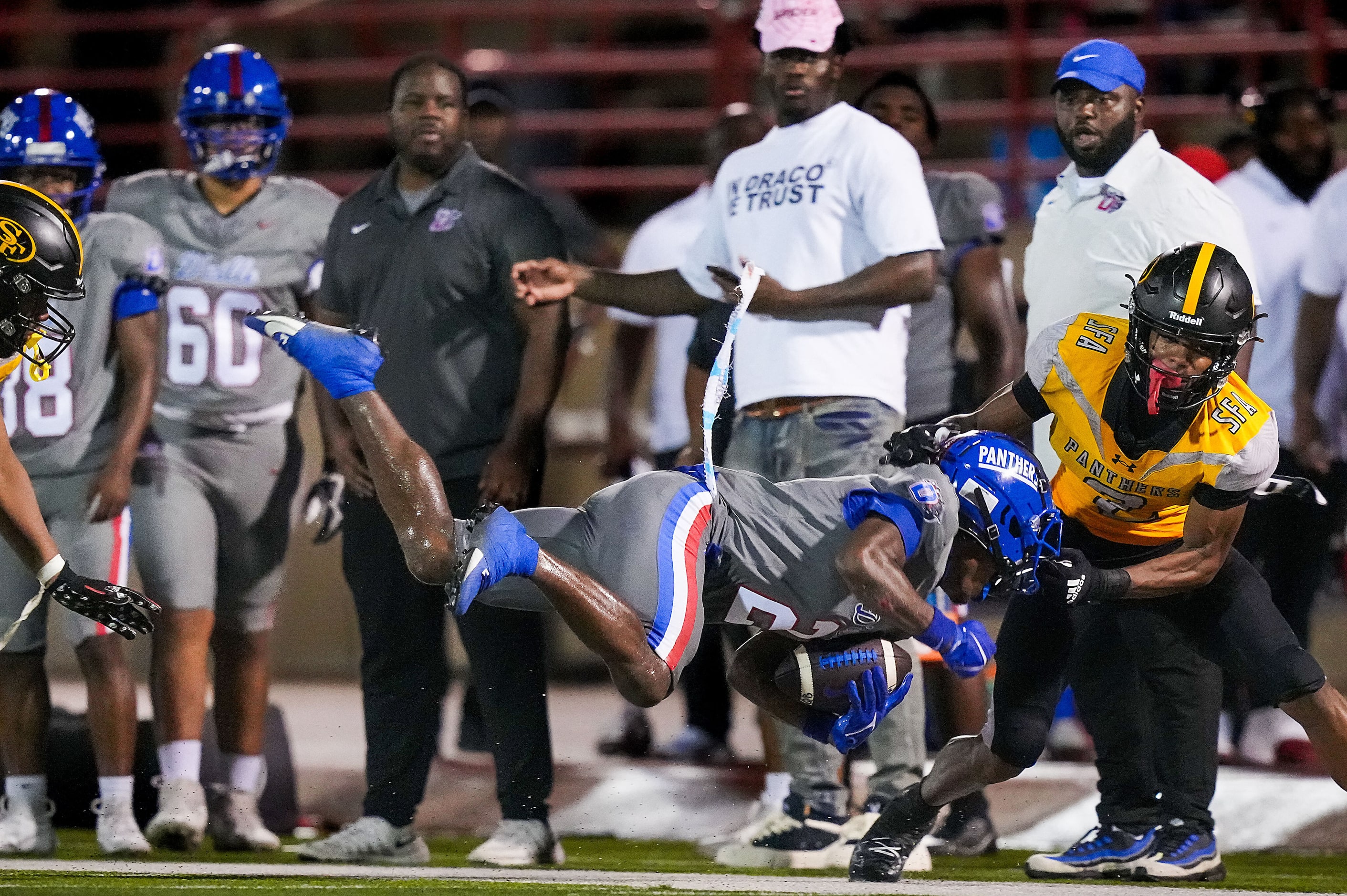 Duncanville wide receiver Ayson Theus is pulled down by his facemask by St. Frances Academy...