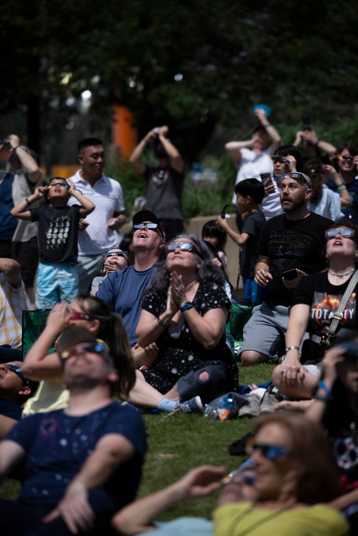 People watch the eclipse near totality during the Great North American Eclipse event at the...