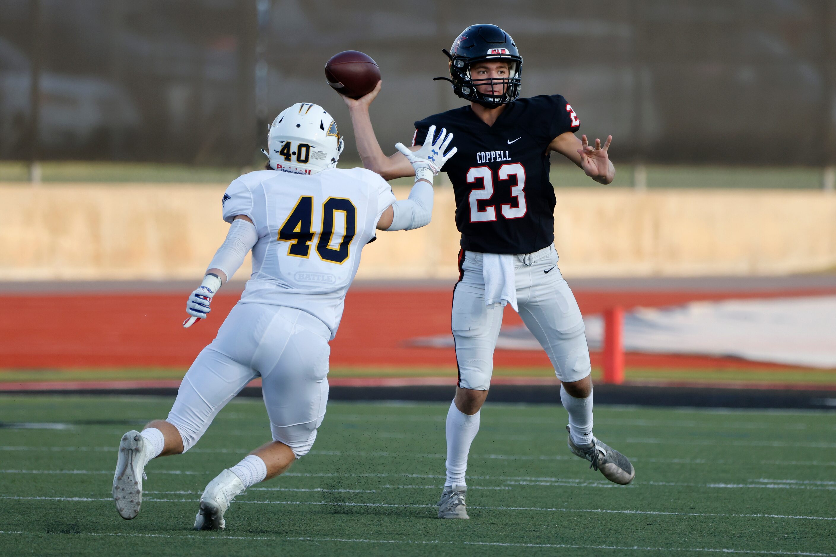 Coppell quarterback Jack Fishpaw (23) gets off a pass while being pressured by Prestonwood...