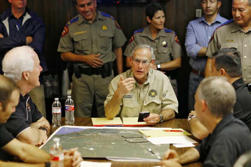 Texas Gov. Greg Abbott gathered with others to coordinate services in the wake of Hurricane...