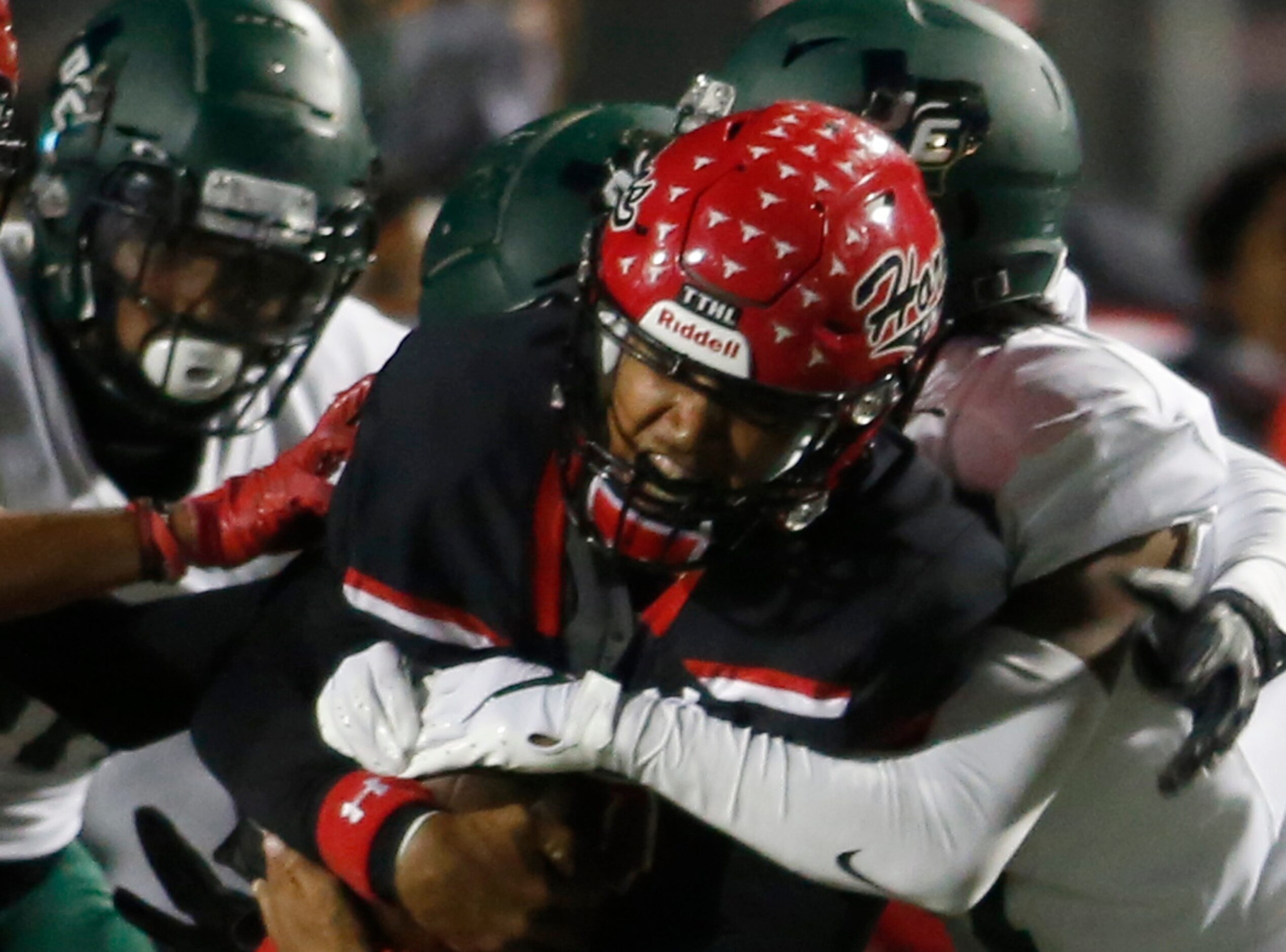 Cedar Hill quarterback Kaidon Salter (7) exhibits determination and athleticism as he...