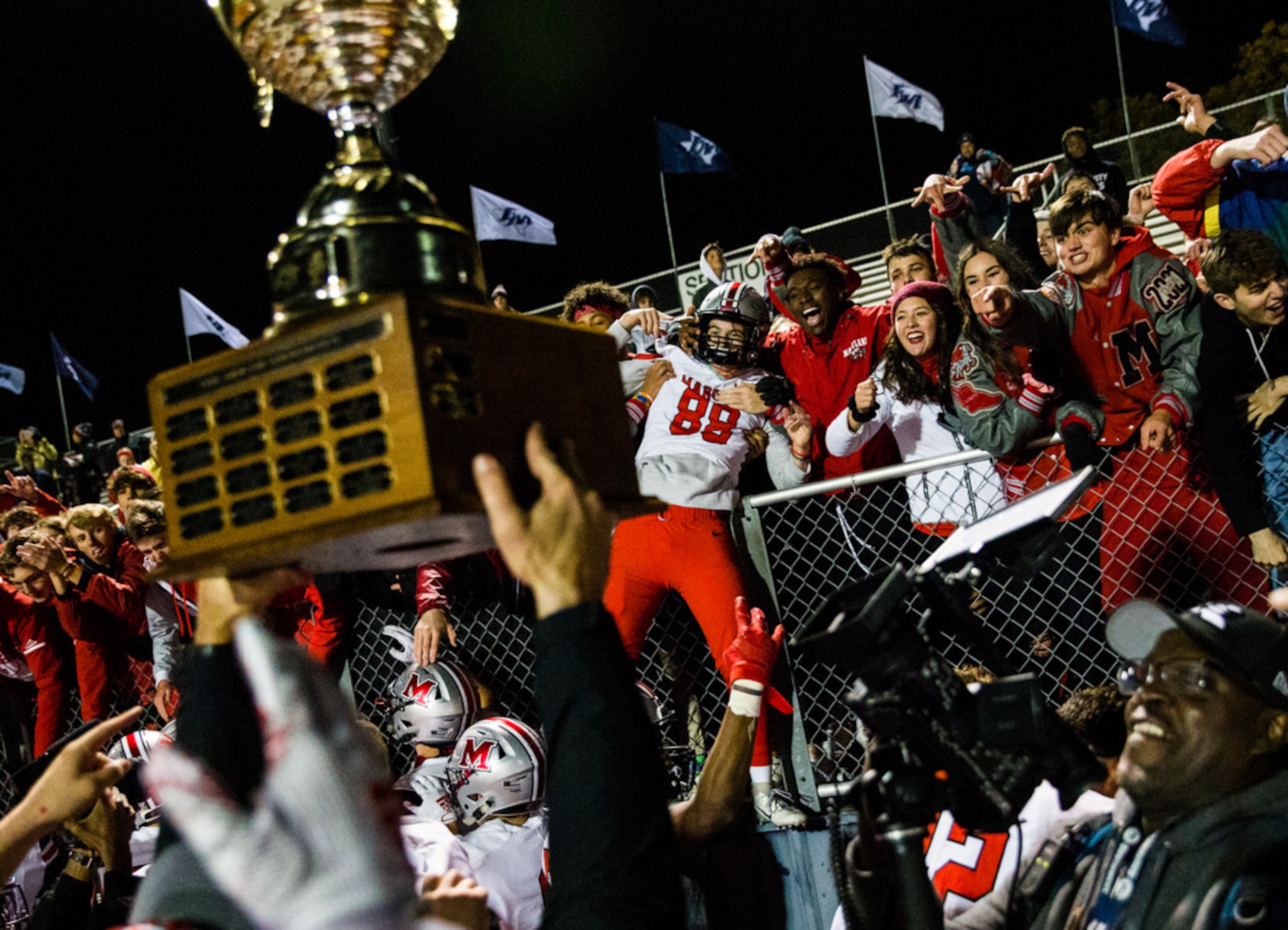 Flower Mound Marcus defensive lineman Stone Raunam (88) celebrates with fans while his...