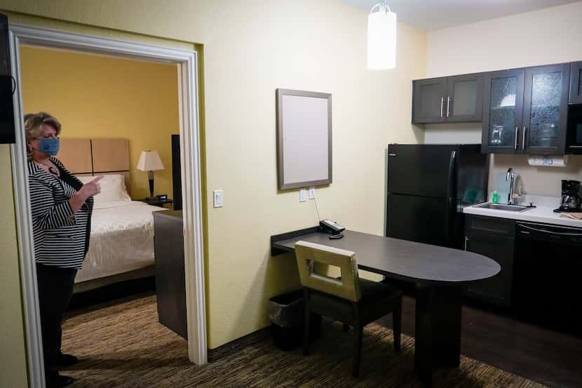 Dallas council member Cara Mendelsohn tours a room at the Candlewood Suites. The $6 million...