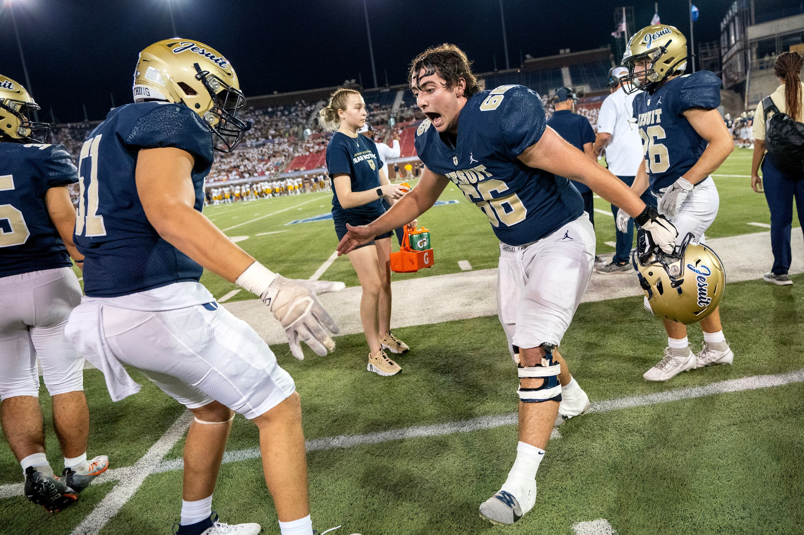 Jesuit senior offensive lineman Ben Petroff (66) celebrates a touchdown with junior...