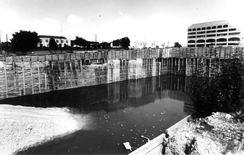 A 90-foot-deep hole filled with water at Cole and Lemmon in Uptown was a symbol of the real...