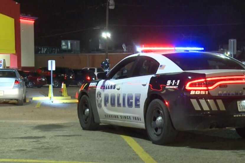 A Dallas police squad car sits outside a west Oak Cliff grocery store where a man was shot...
