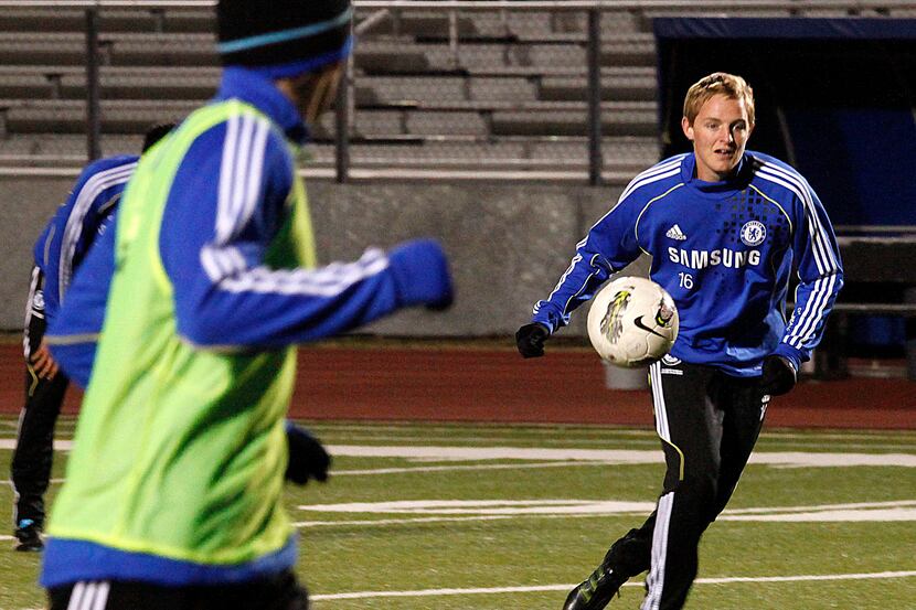 Solar Chelsea Academy player Ryan Condotta (right), (16) passes the soccer ball during...