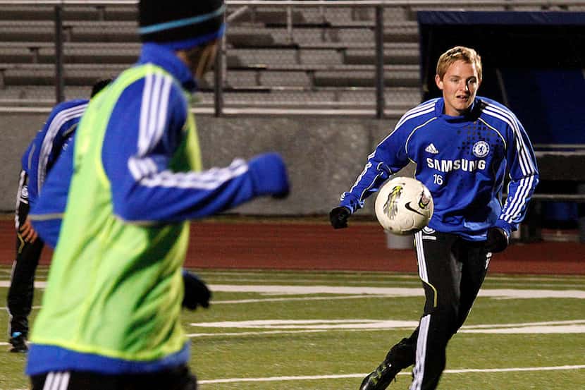 Solar Chelsea Academy player Ryan Condotta (right), (16) passes the soccer ball during...