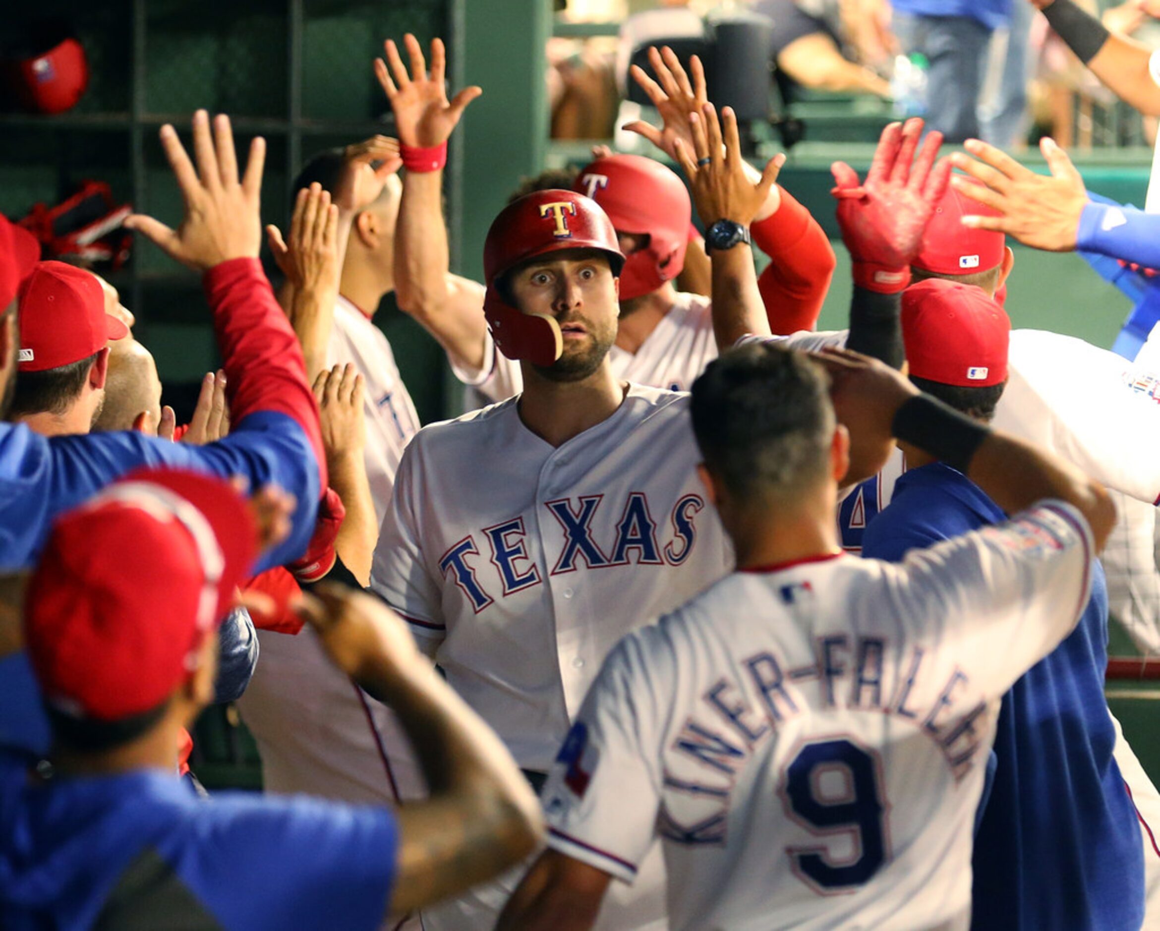 ARLINGTON, TEXAS - MAY 31: Joey Gallo #13 of the Texas Rangers is greeted in the dugout...