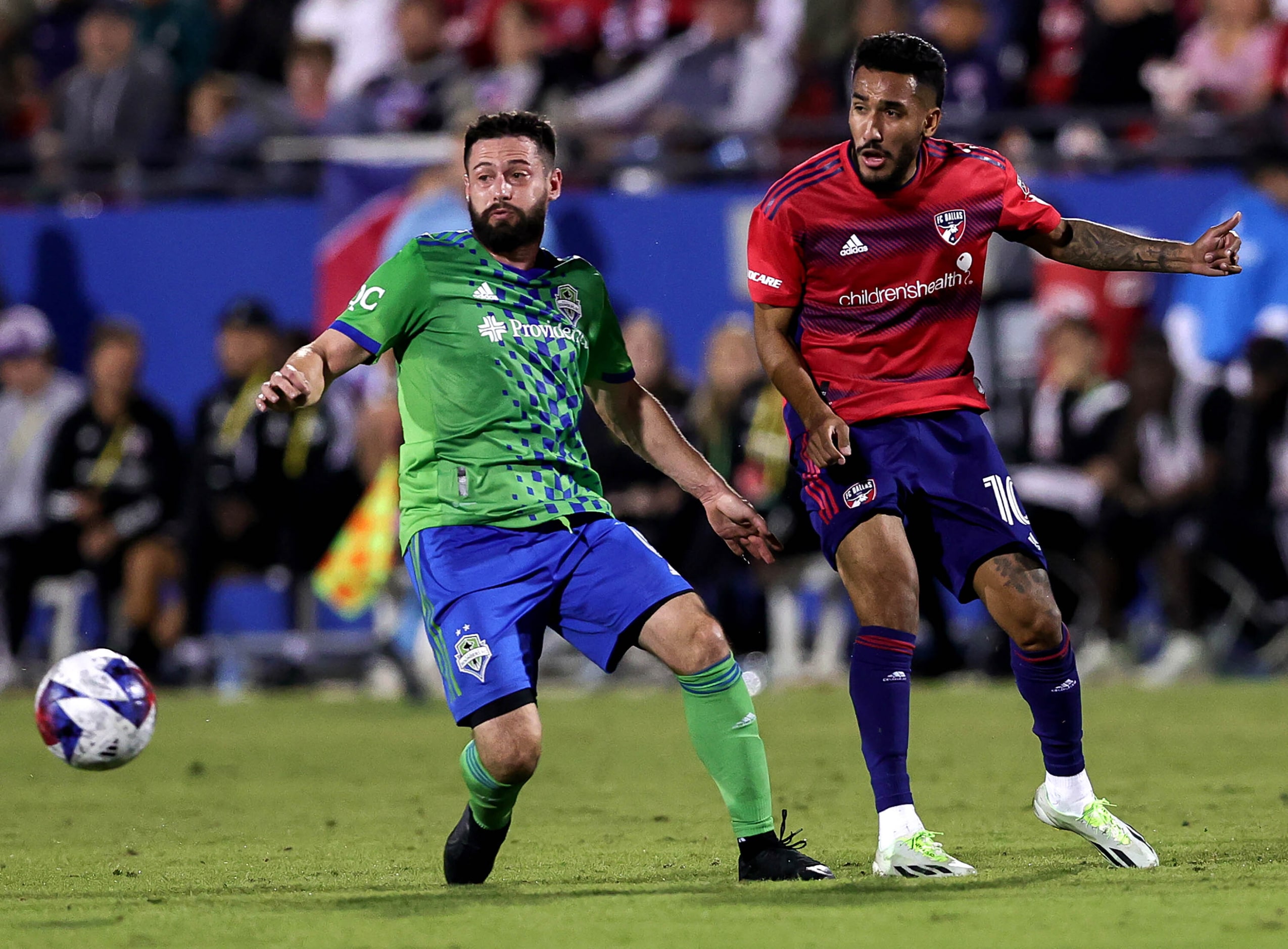 FC Dallas attacker Jesus Ferreira (right) and Seattle midfielder Joao Paulo (left) go for a...