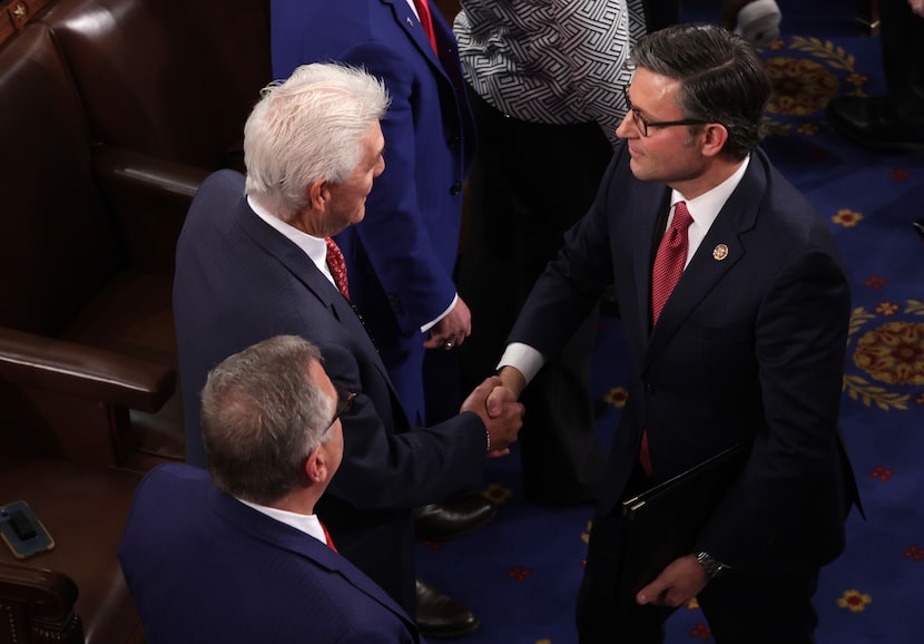 Rep. Roger Williams, R-Willow Park, congratulates newly elected House Speaker Mike Johnson...