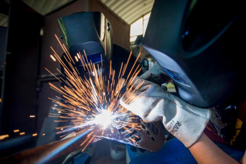 
Welding instructor Daniel Sellers (left) watches as student Joseph Sawyer uses an arc...
