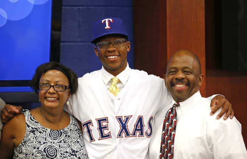 Texas Rangers top draft pick Dillon Tate, center, with his mother Lenora, left, and father...