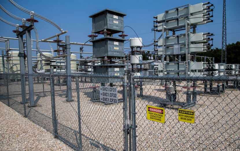 High voltage signs are displayed at an Oncor Static VAR Compensator in east Dallas on...