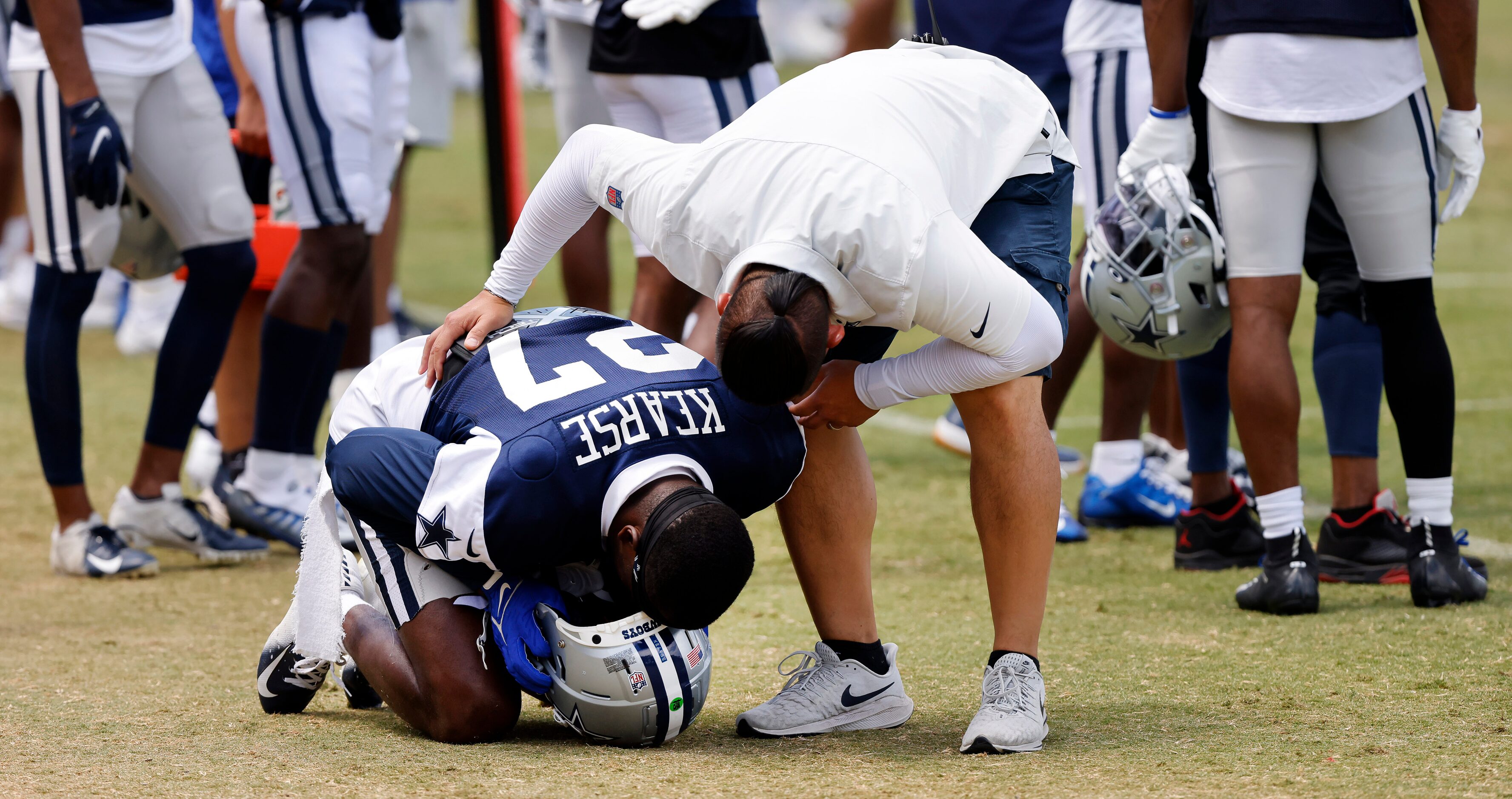 Dallas Cowboys safety Jayron Kearse (27) doubles over on the sideline after tweaking his...