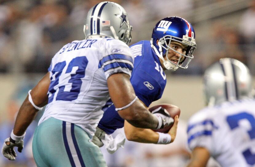 NY QB Eli Manning scrambles away from the rush in the fourth quarter in New York's 33-31 win...