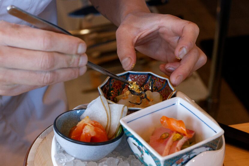 Owner and chef Leo Kekoa places gold flakes onto flounder at Kinzo Sushi in Frisco.