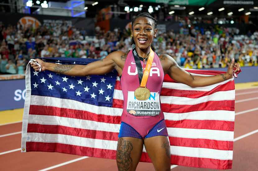 Sha'Carri Richardson of the United States poses after winning the gold medal and setting a...