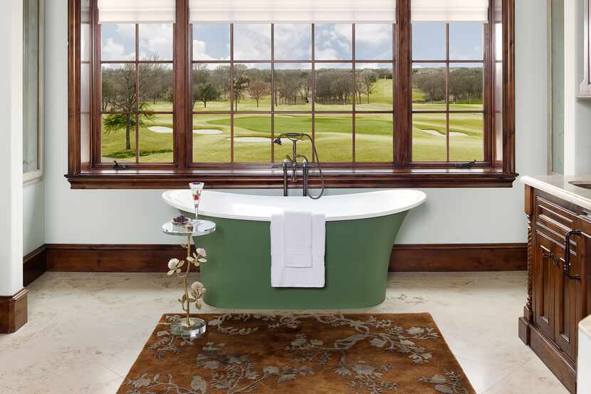 An old world-style bathroom boasts a green bathtub.
