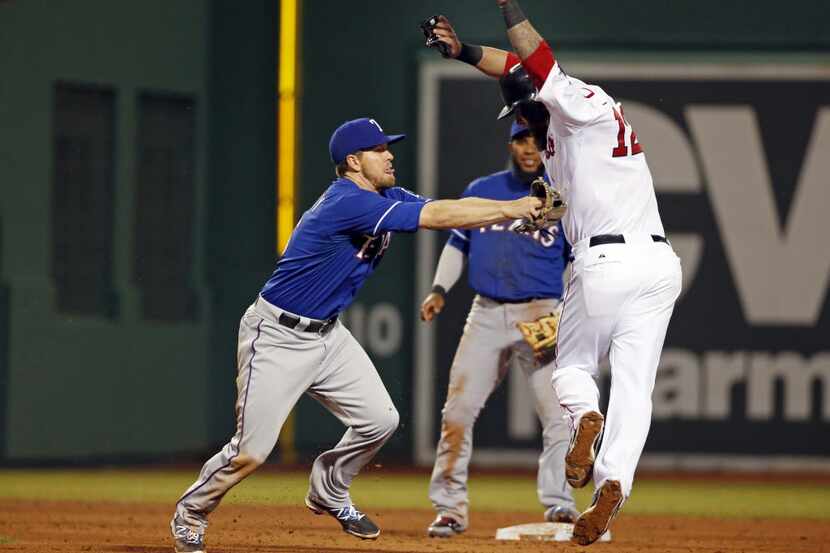 Texas Rangers second baseman Donnie Murphy reaches to tag out Boston Red Sox's Mike Napoli...