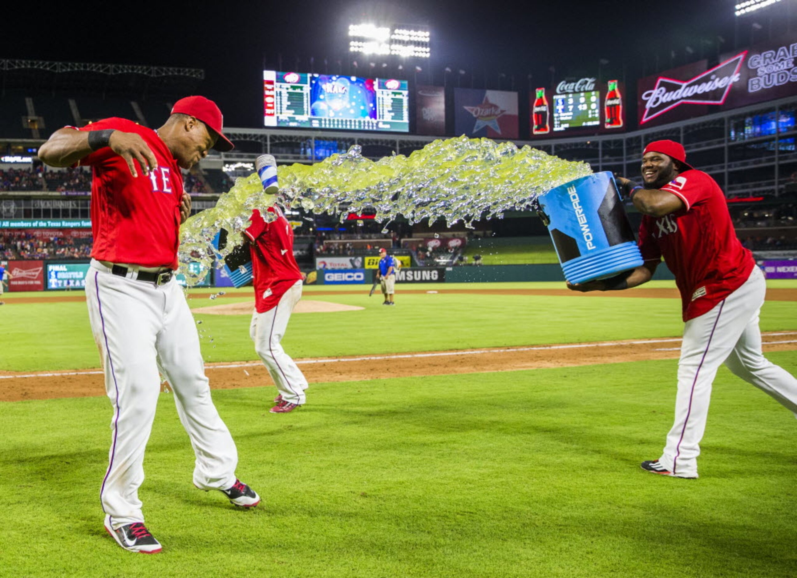 Texas Rangers third baseman Adrian Beltre (29) jumps back from a Gatorade dump by shortstop...