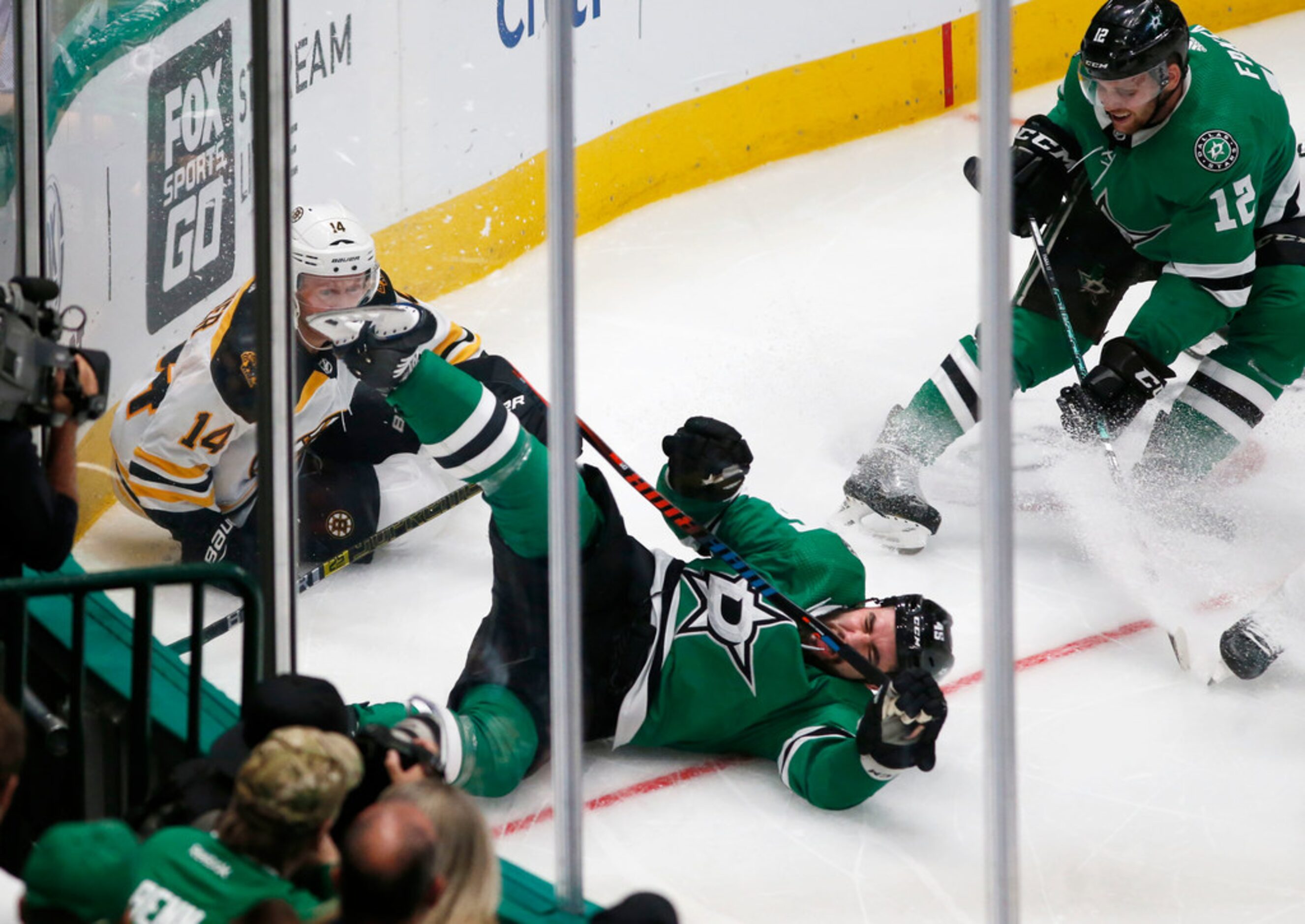 Dallas Stars defenseman Roman Polak (45) runs into the wall with Boston Bruins right wing...