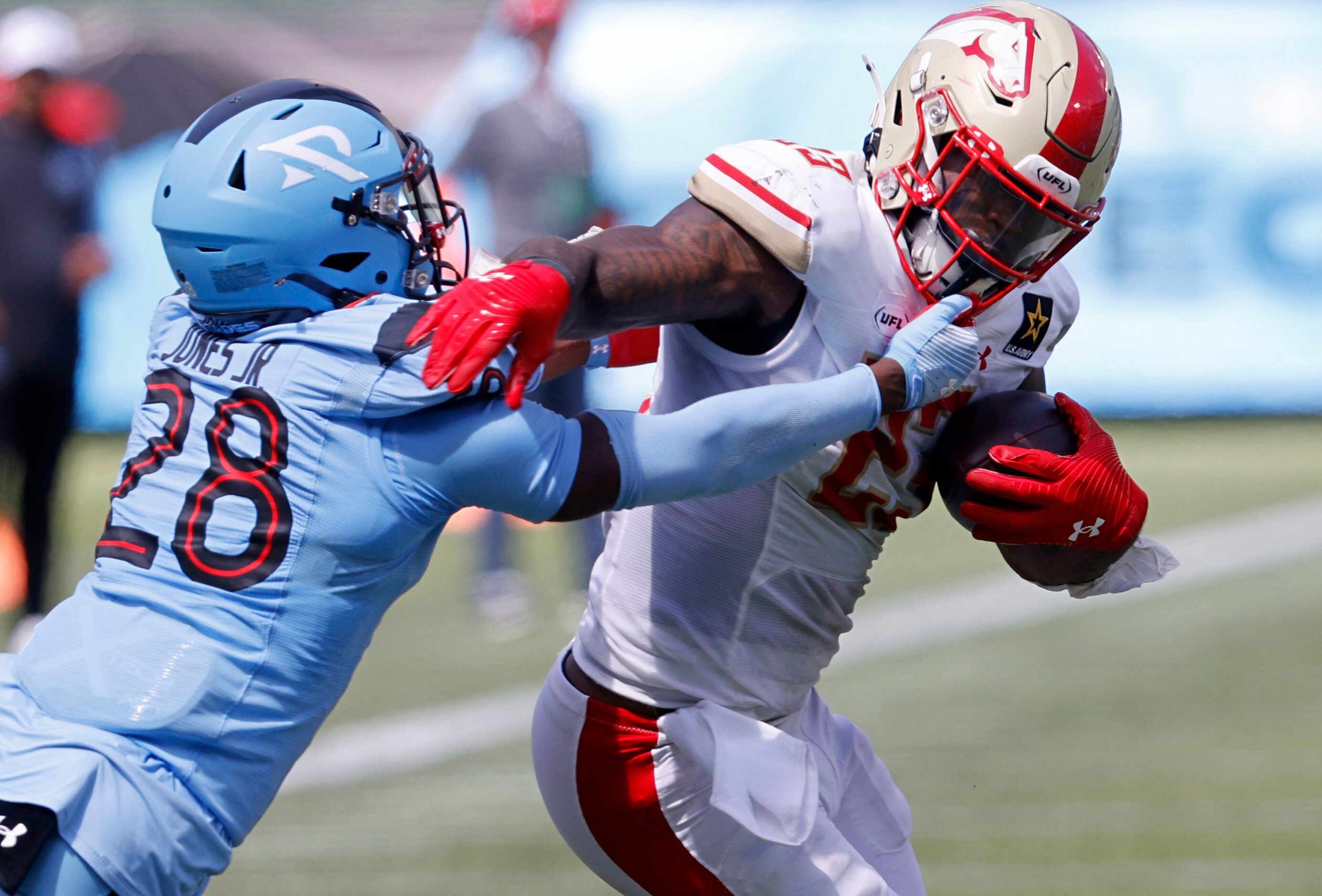 Birmingham Stallions running back Ricky Person Jr. (23) keeps the ball away from  Arlington...